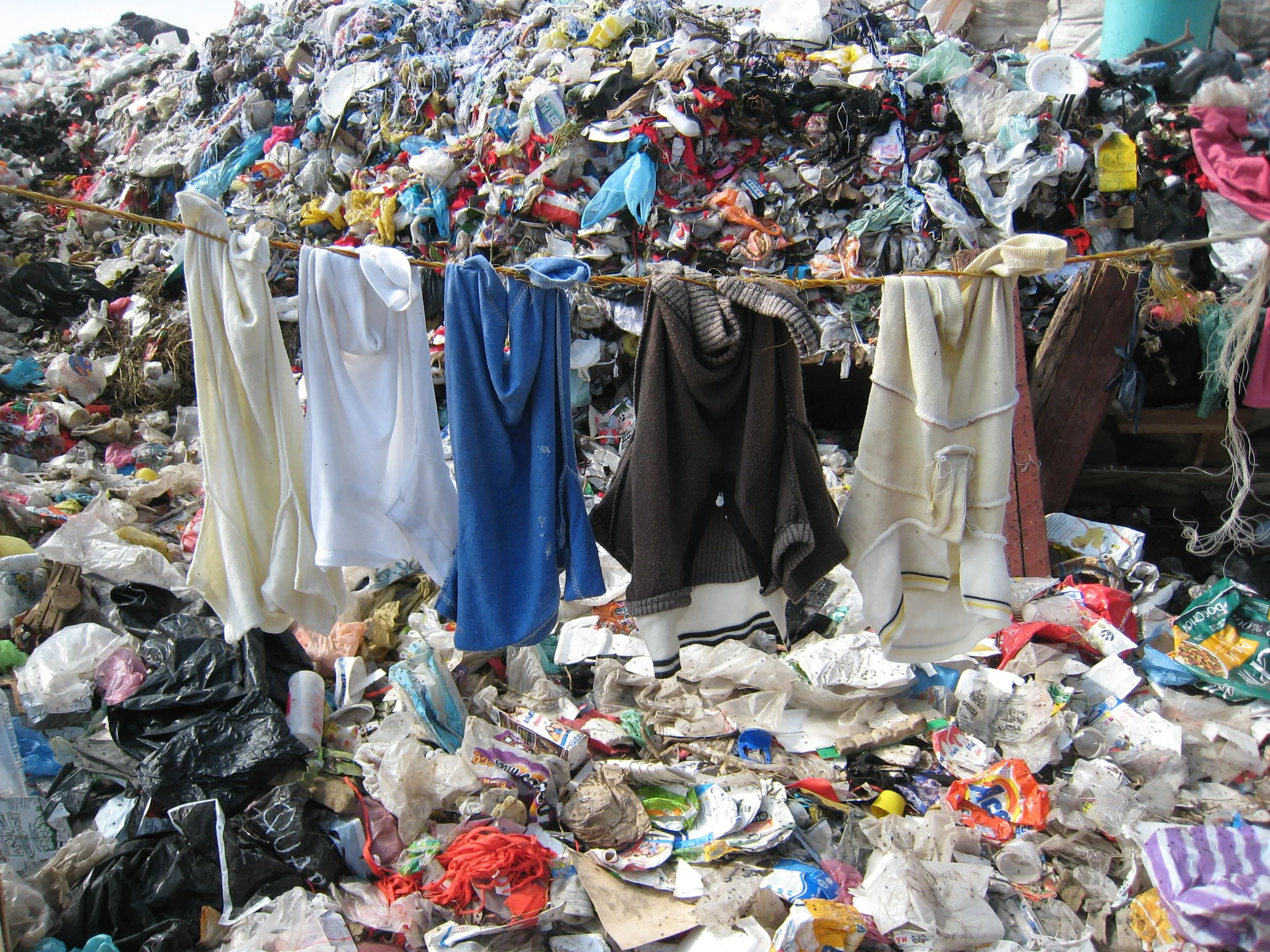  Clothing from cheap fast fashion brands ends up in foreign trash dump, such as this one near Mexico City.                         Photo courtesy of The Donkey Sanctuary.   