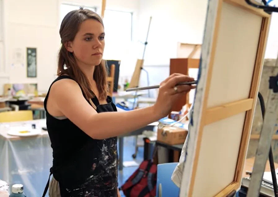 Art student Sam Rankin painting a piece for her undergraduate summer fellowship program. Photo by Miao Nie. 