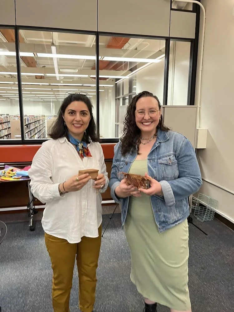  MFA artist Negar Farajiani (left) pictured with curator Letícia Cobra Lima (right) holding their personal boxes after Gather and Graft, an arts workshop in collaboration with the “A Box of One’s Own: Women Beyond Borders,”  at UCSB’s Art, Design and Architecture Museum. 