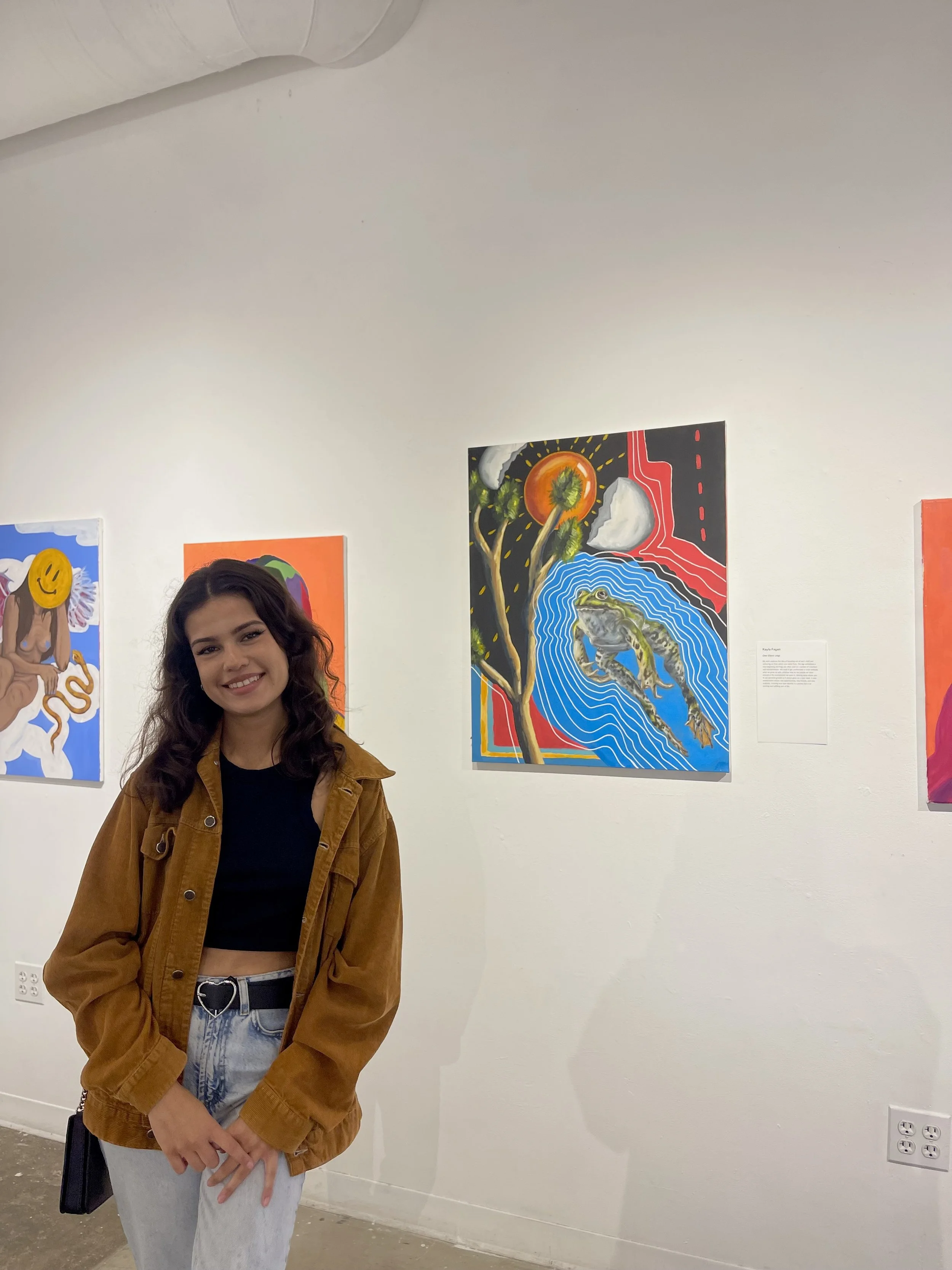  Student artist Kayla Fagan with her painting titled, “One Giant Leap.” 