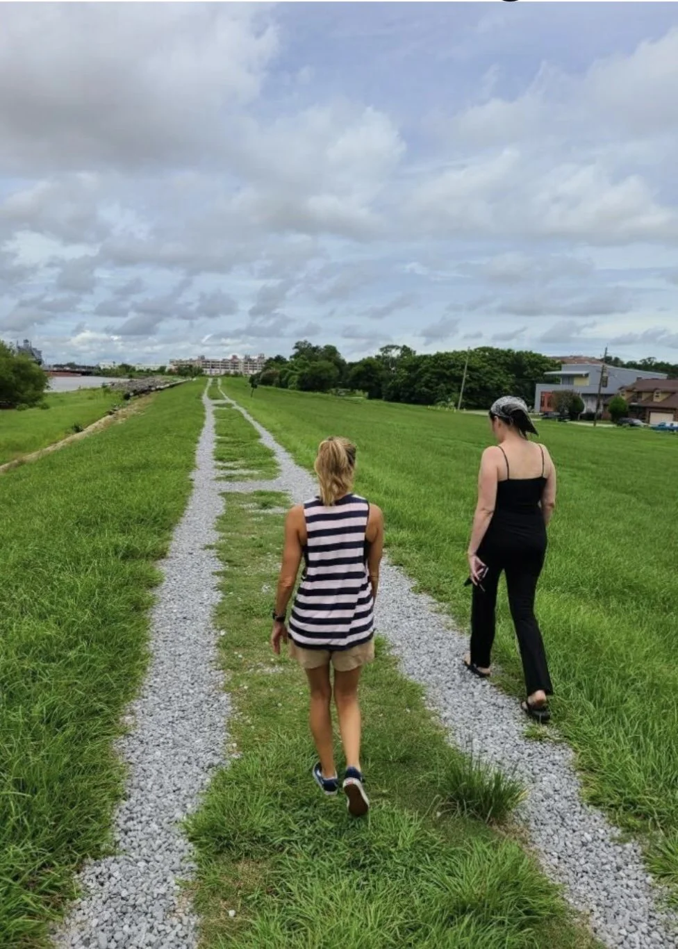  UCSB Continuing Lecturer Sarah Hirsch, left, and New Orleans resident Laura Paul walk on the levee in the Ninth Ward. Paul is part of Lower Nine,  a non-profit organization founded after Hurricane Katrina in 2005 to help the historic neighborhood recover. 