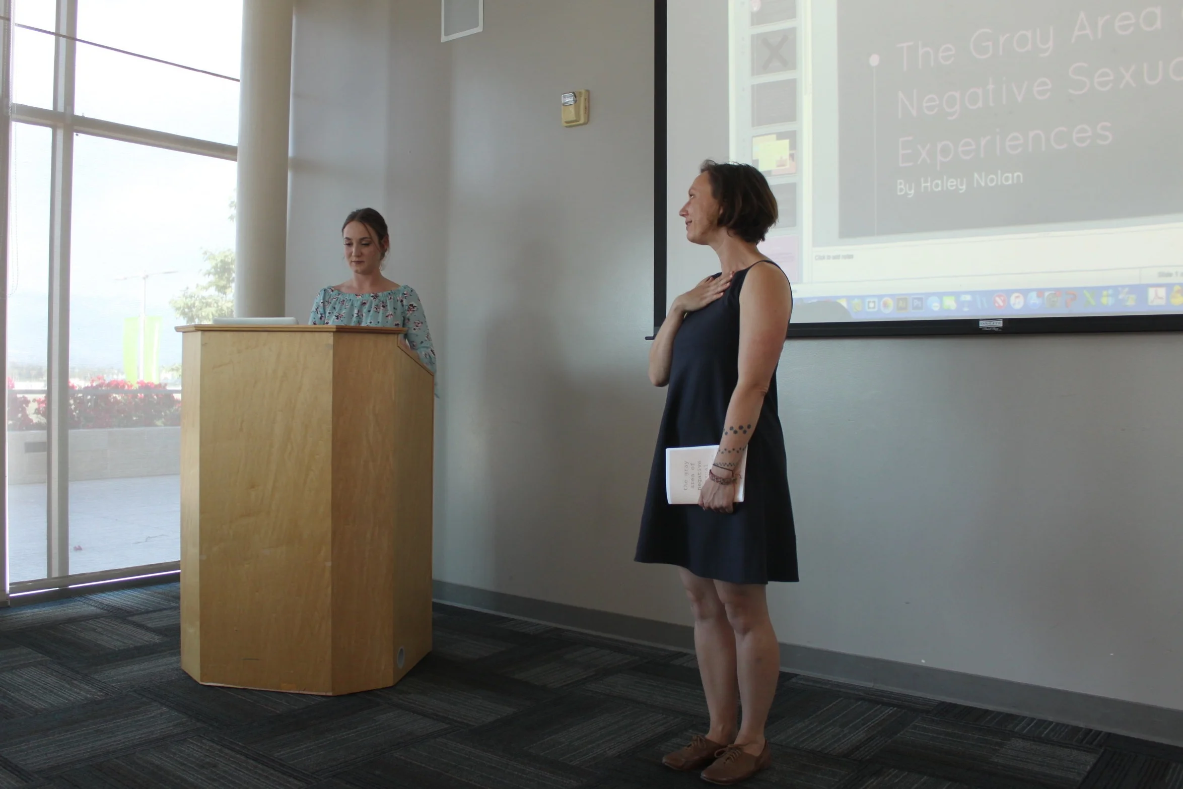  Writing Program faculty member Patricia Fancher, introduces her mentee Haley Nolan at the Raab Writing Fellows Showcase. 