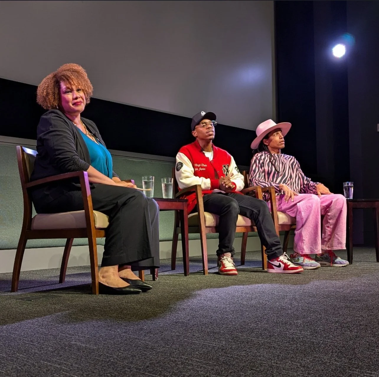   UCSB English, Dance, and Black Studies Professor Stephanie Batiste, left, leads a post-screening Q&A in UCSB's Pollock Theater with Lil Buck, center, and Jon Boogz. The choreographers spoke about their careers and the Netflix documentary “Move.”  