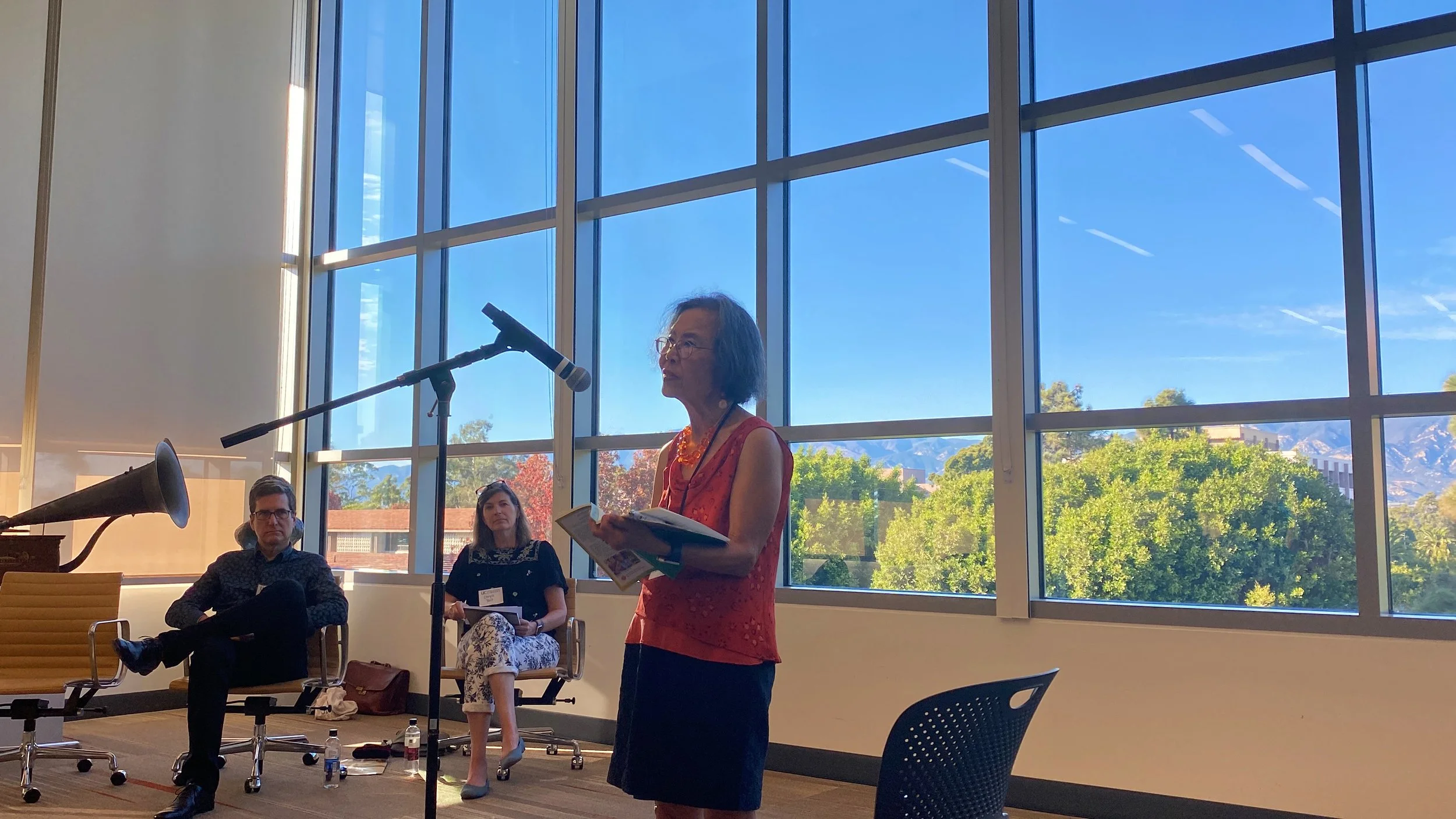  UC Santa Barbara English professor emerita Shirley Geok-lin Lim, reading from her newly published poetry collection “In Praise of Limes” at an open mic poem reading event hosted by the UCSB Library.  George Yatchisin, back left, and Chryss Yost, back right., of the Gevirtz School of Education also read. 