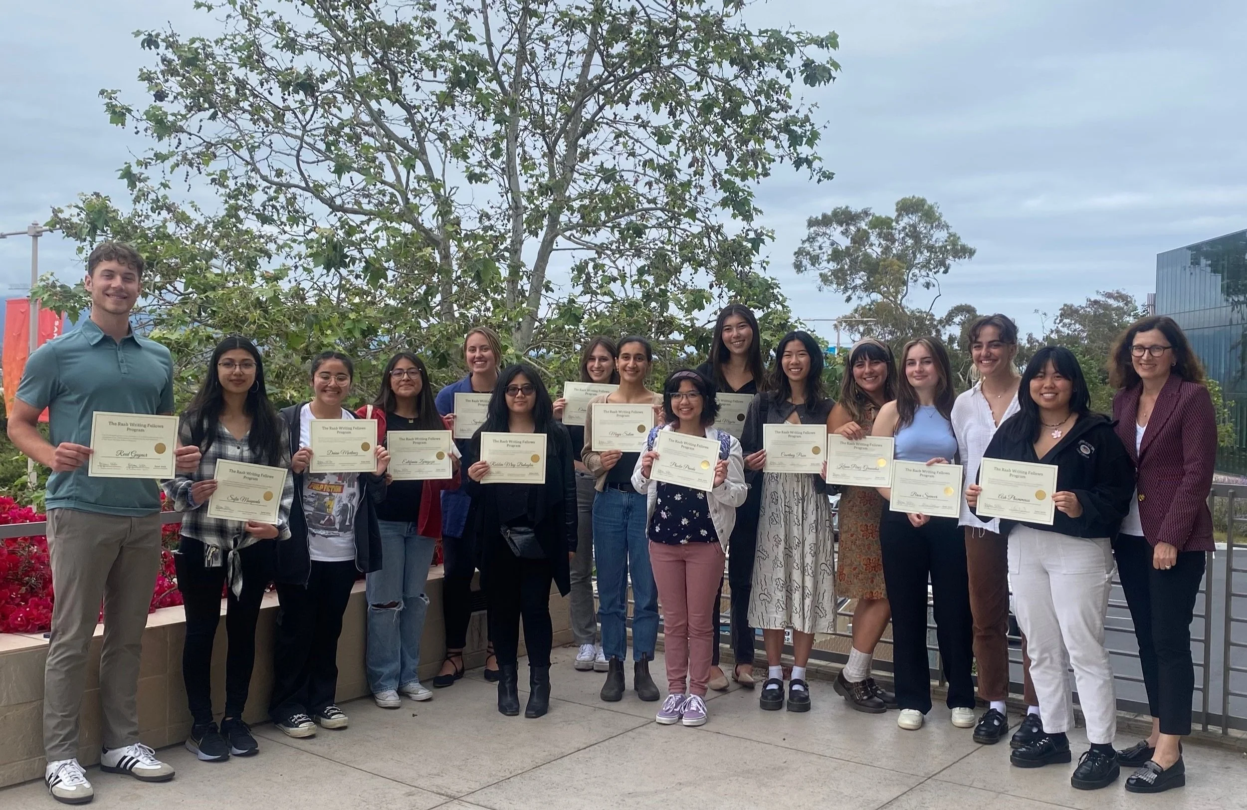  The 2023 UCSB Raab Writing Fellows with program director Ljiljana Coklin, far right, holding their certificates at the end of the showcase.  