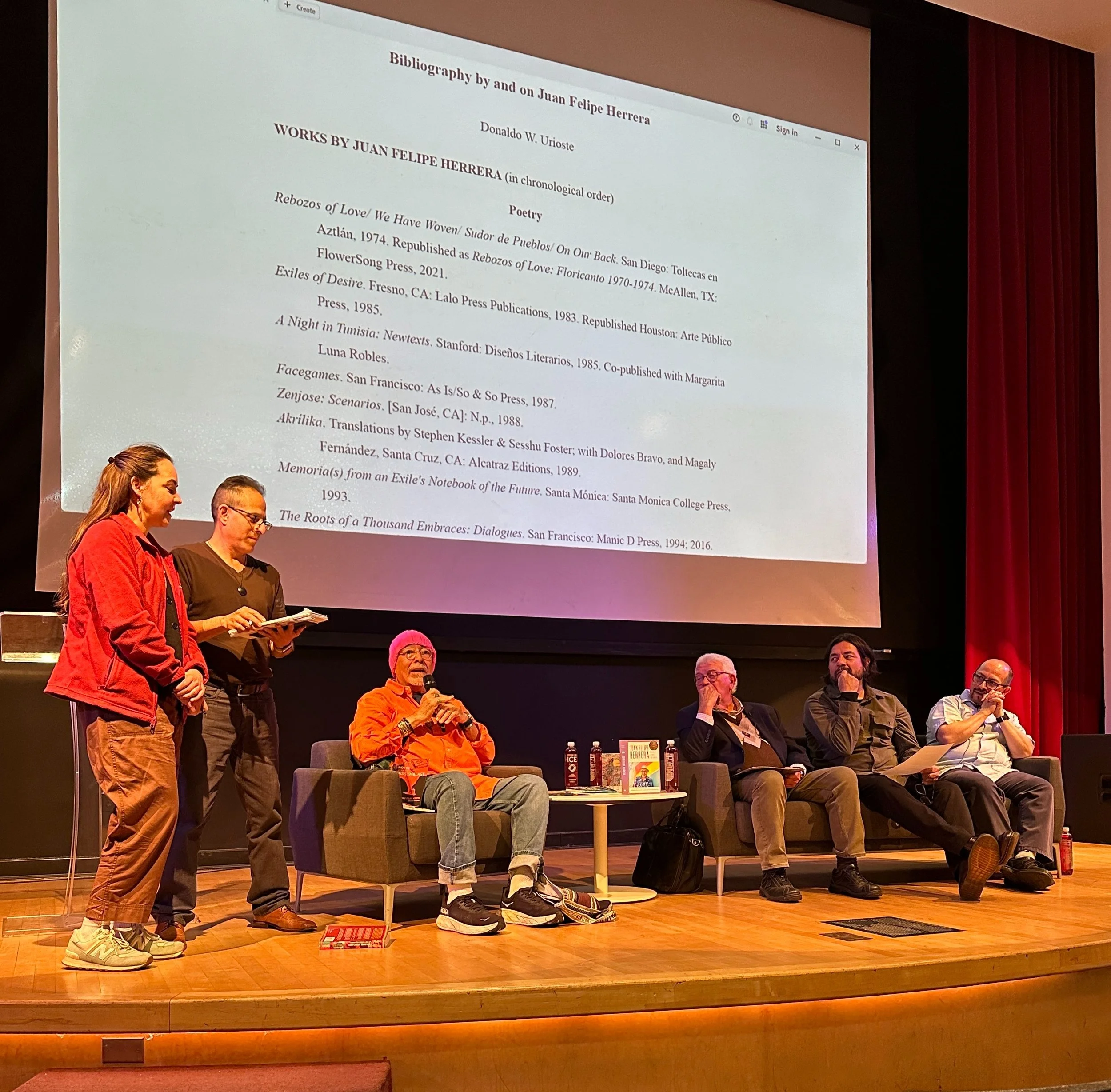   Poet Juan Felipe Herrera, third from left, asked members of the audience to perform poetry with him during his poetry and spoken word event .  