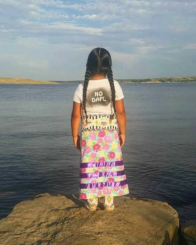  An Indigenous child protesting the Dakota Access Pipeline in 2016. Photo by Tiffany Baker 