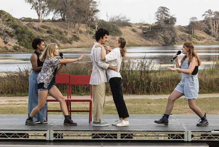  From left to right, actors Rae Farnum, Caroline Ware, Angel Villalobos, Lana Spring, and Andalyn Honselaar performing in Twelfth Night front of the UC Santa Barbara lagoon.  