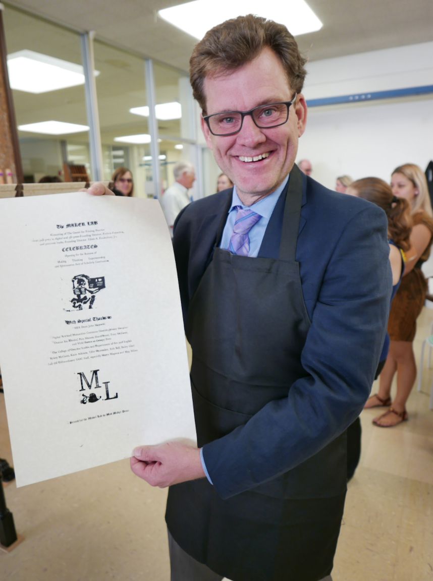  Dean John Majewski shows off his commemorative print fresh from the printing press. 