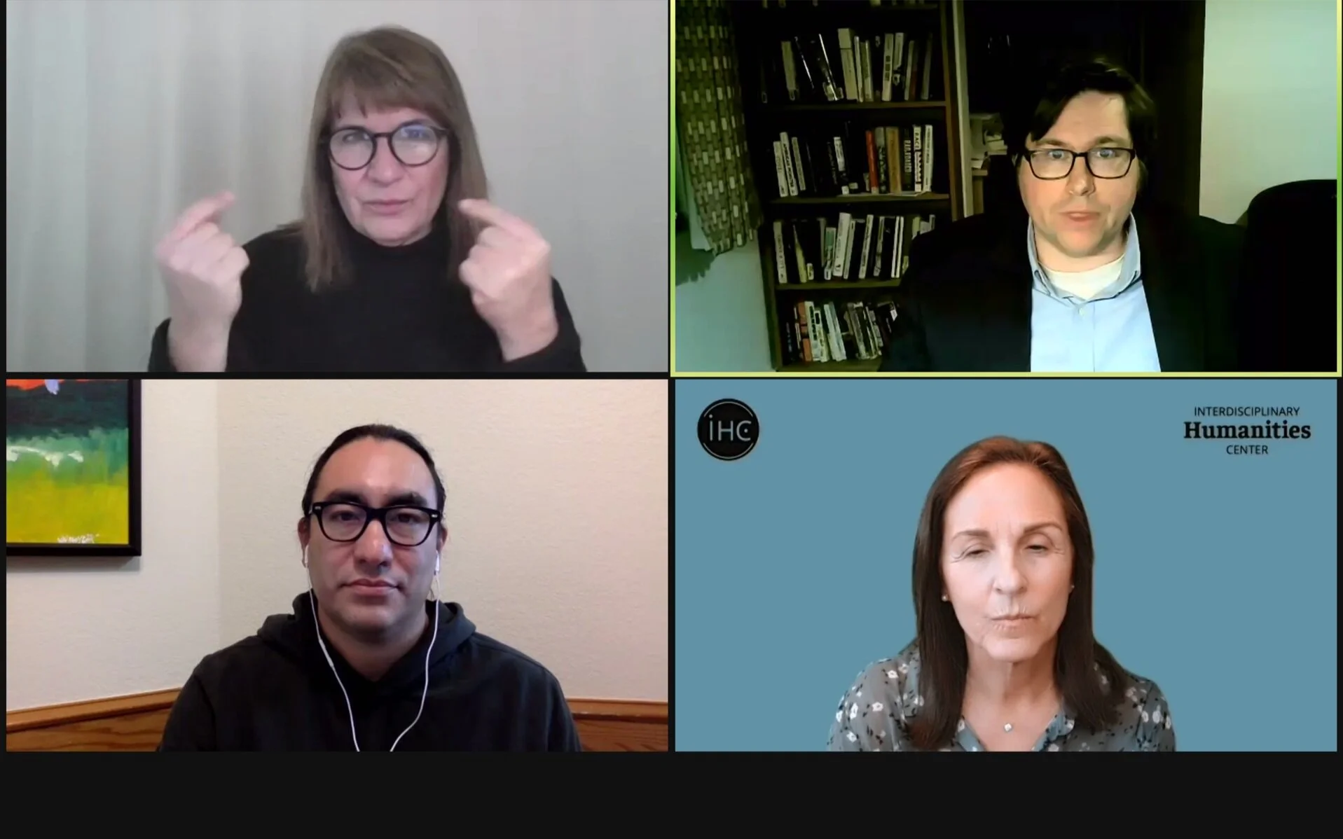  Journalist Tristan Ahtone , bottom left, historian Robert Lee, upper right, American Sign Language translator Jo Malizia, upper left, and event host IHC Director Susan Derwin, bottom right, discuss how indigenous lands were turned into university endowments.  Photo by Hannah Z. Morley  