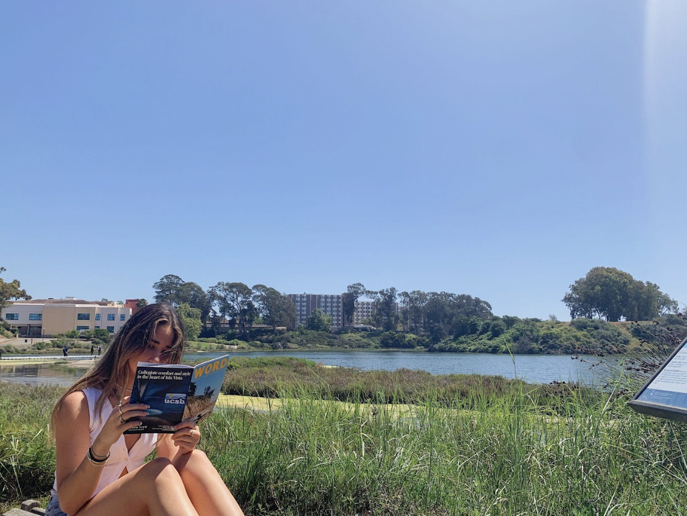  Sophomore Abby Sovik enjoys WORD’s fall 2021 issue by the UCSB Lagoon. 