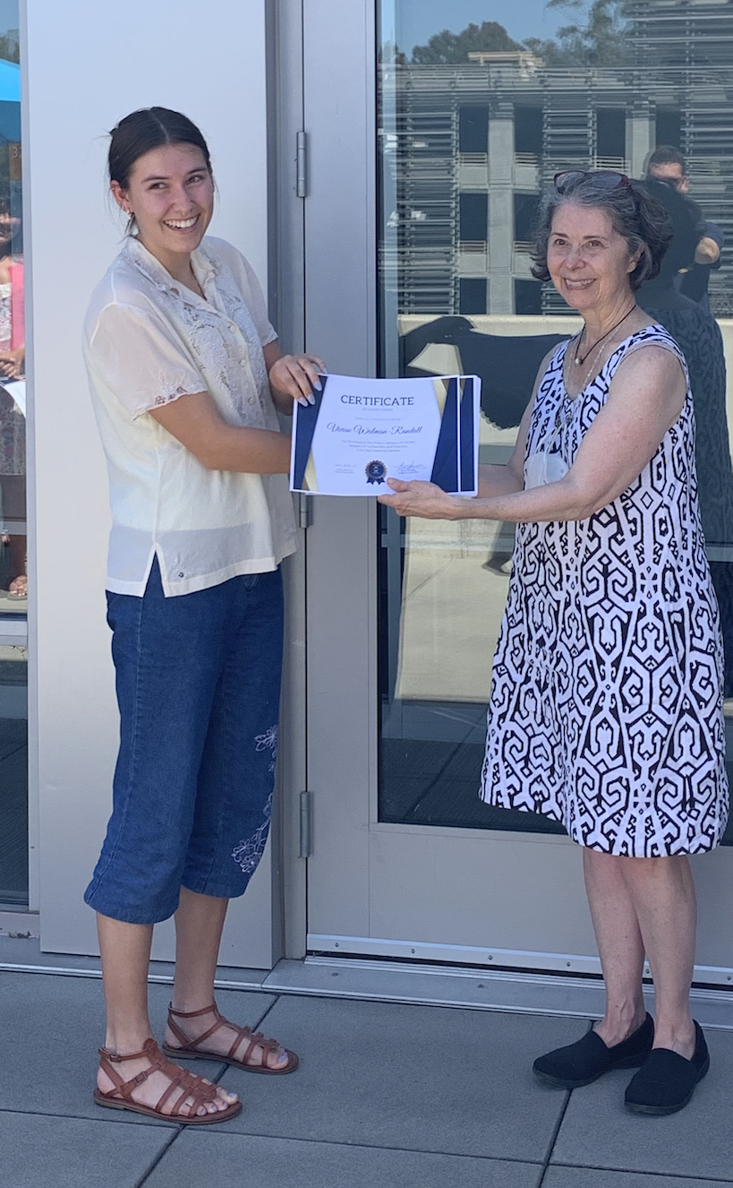  At a lunch event, the third-place winner in the poetry category for HFA's creativity contest, Vivian Walman-Randall, accepted her award from the Acting Dean of Humanities and Fine Arts, Mary Hancock. 
