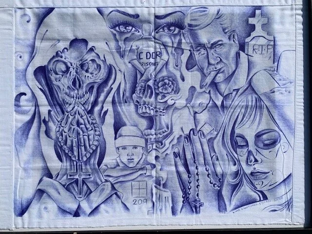  Currently-incarcerated artist Luis Martinez creates artwork with a homemade shading device on pieces of fabric. This piece, entitled Santa Muerte, is on display in the UCSB Library Mountain Gallery until July 2.  Photos courtesy of the UCSB Library. 