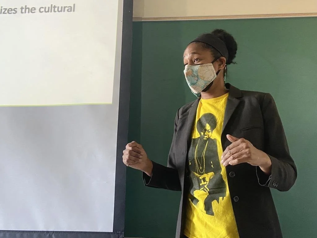  English professor Cathy Thomas answering a student's question about traditional Caribbean Carnival practices, something she currently researches. 