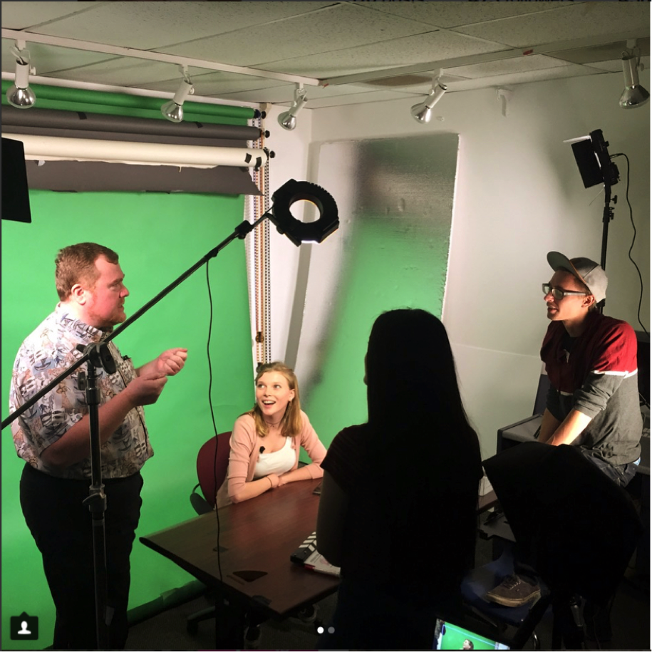  KEYT News producer, Jim Lemon, gives the members of the UCSB TV staff pointers for their show. UCSB TV producer, Celie Mitchard, sits at the studio desk.  Photo courtesy of Celie Mitchard 